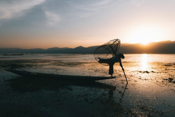 A person standing on a boat in the water