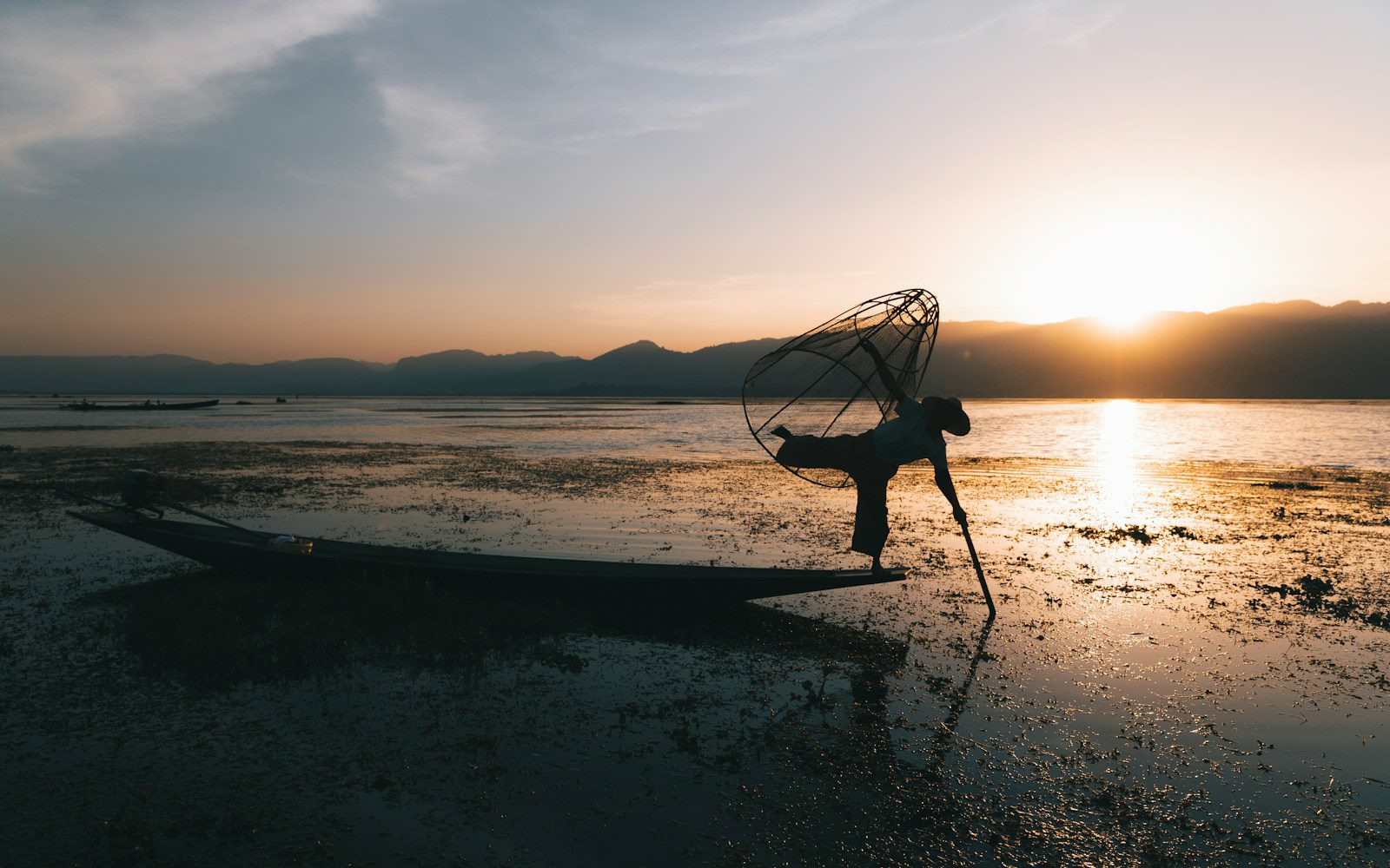 A person standing on a boat in the water