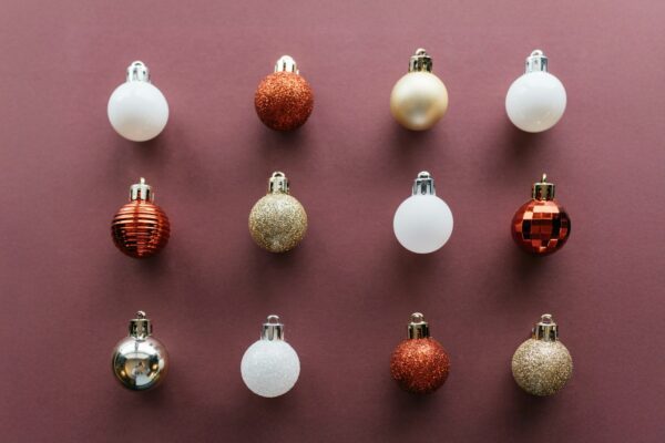 A group of christmas ornaments on a purple surface