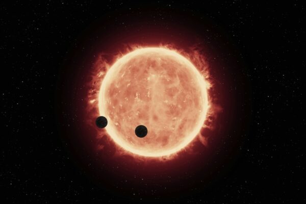 an artist's impression of two planets in front of a star