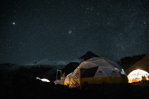 A couple of tents sitting in the middle of a field