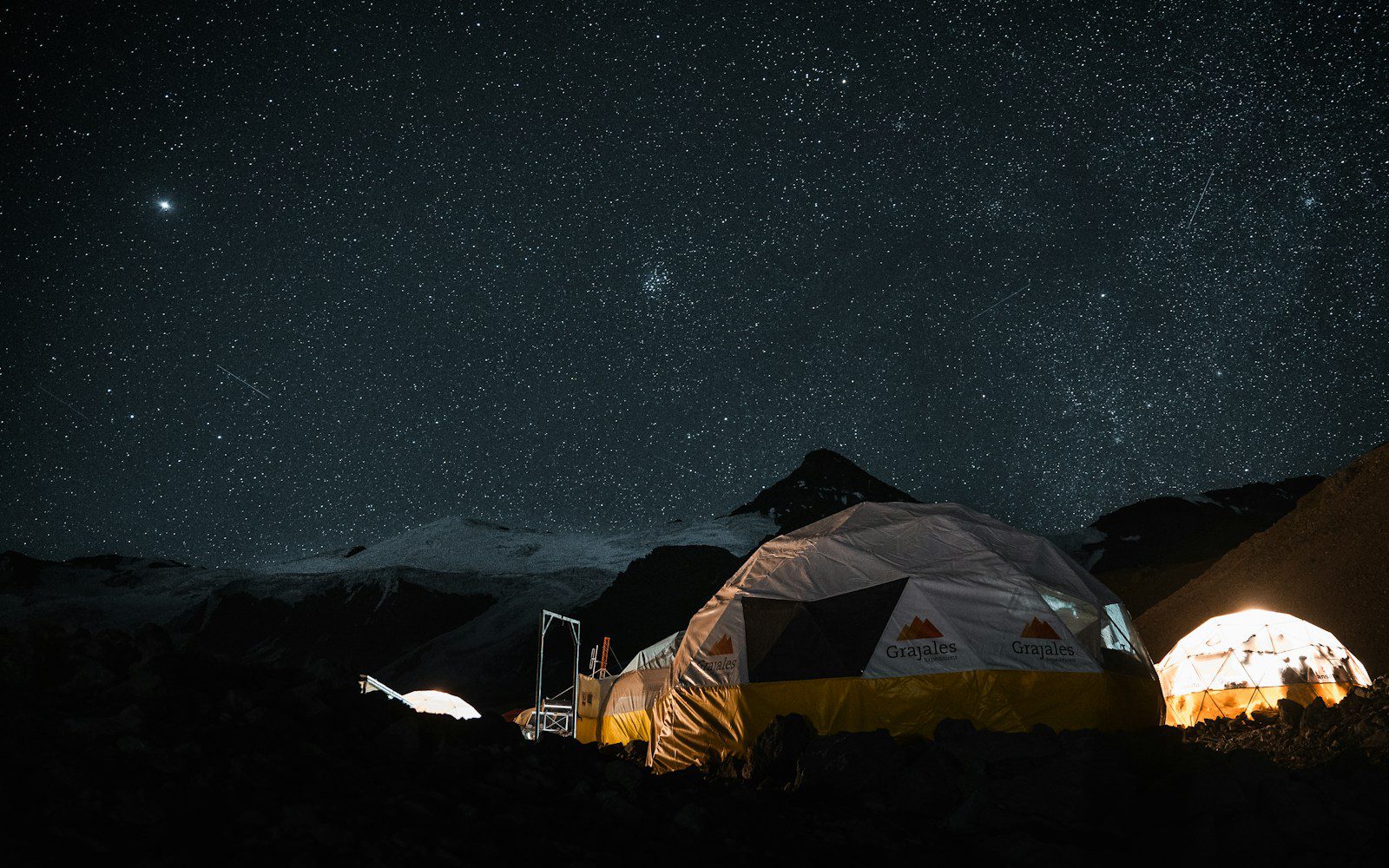 A couple of tents sitting in the middle of a field