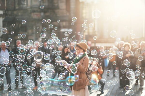 woman standing outdoor surrounded by bobbles during daytime