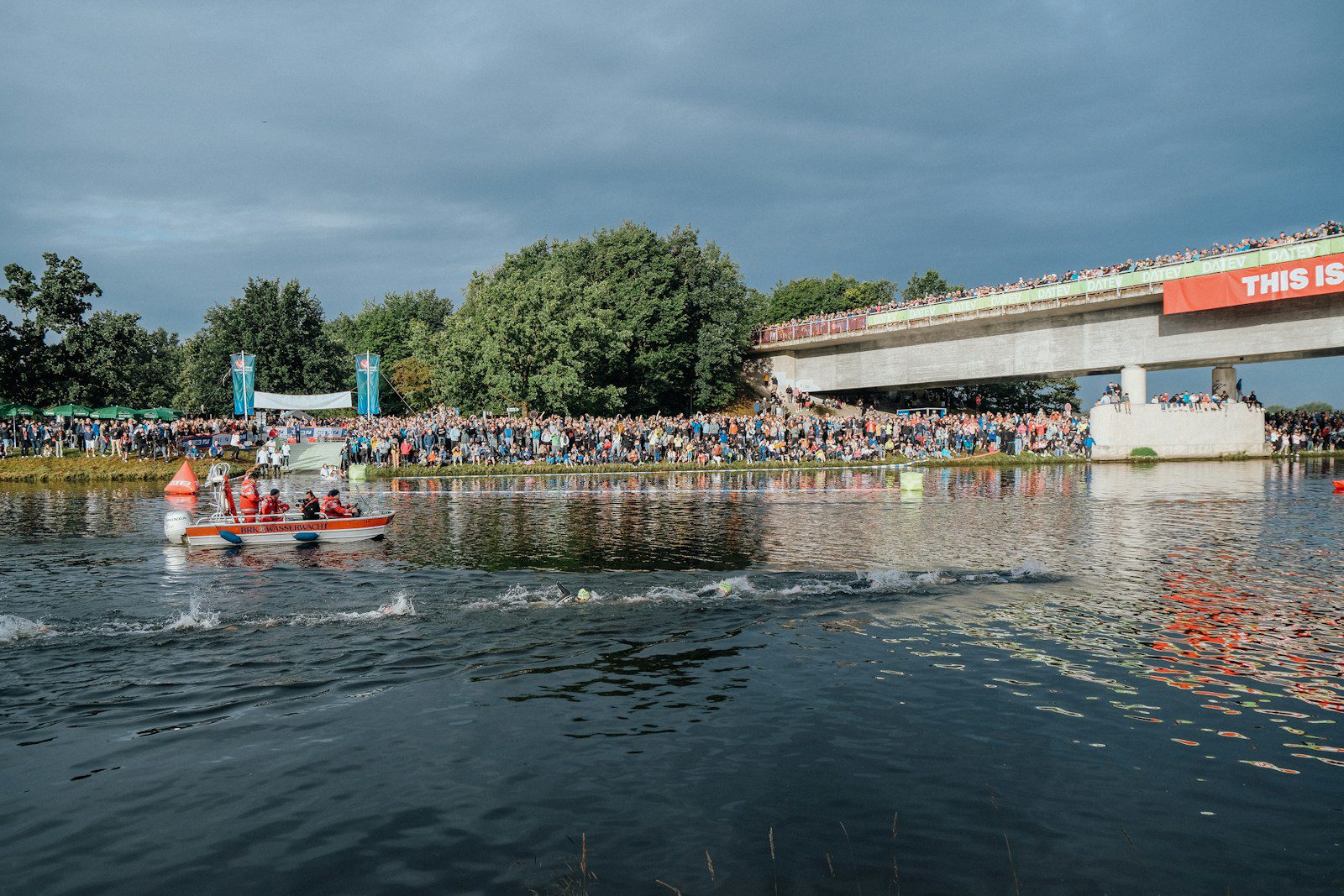 A group of people riding paddle boats on top of a lake