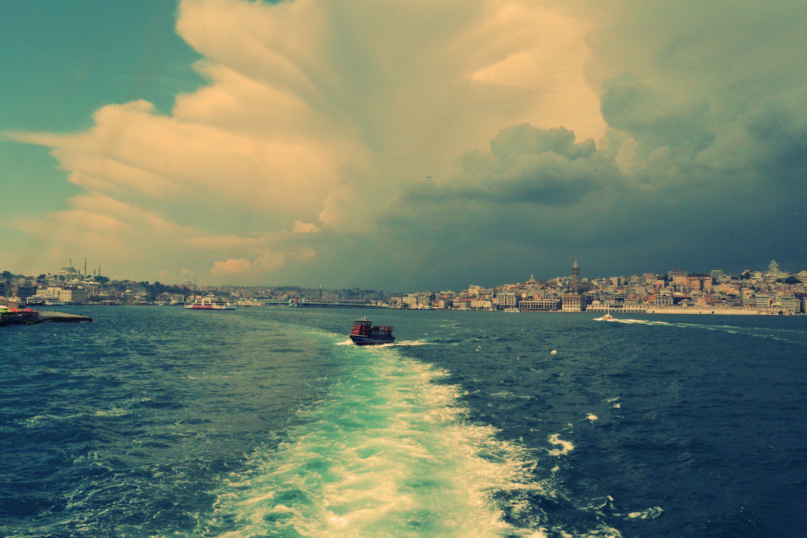 boat on body of water under cloudy blue sky