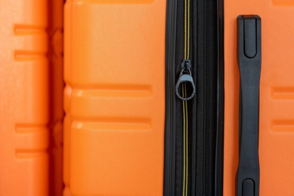 an orange piece of luggage with a black handle