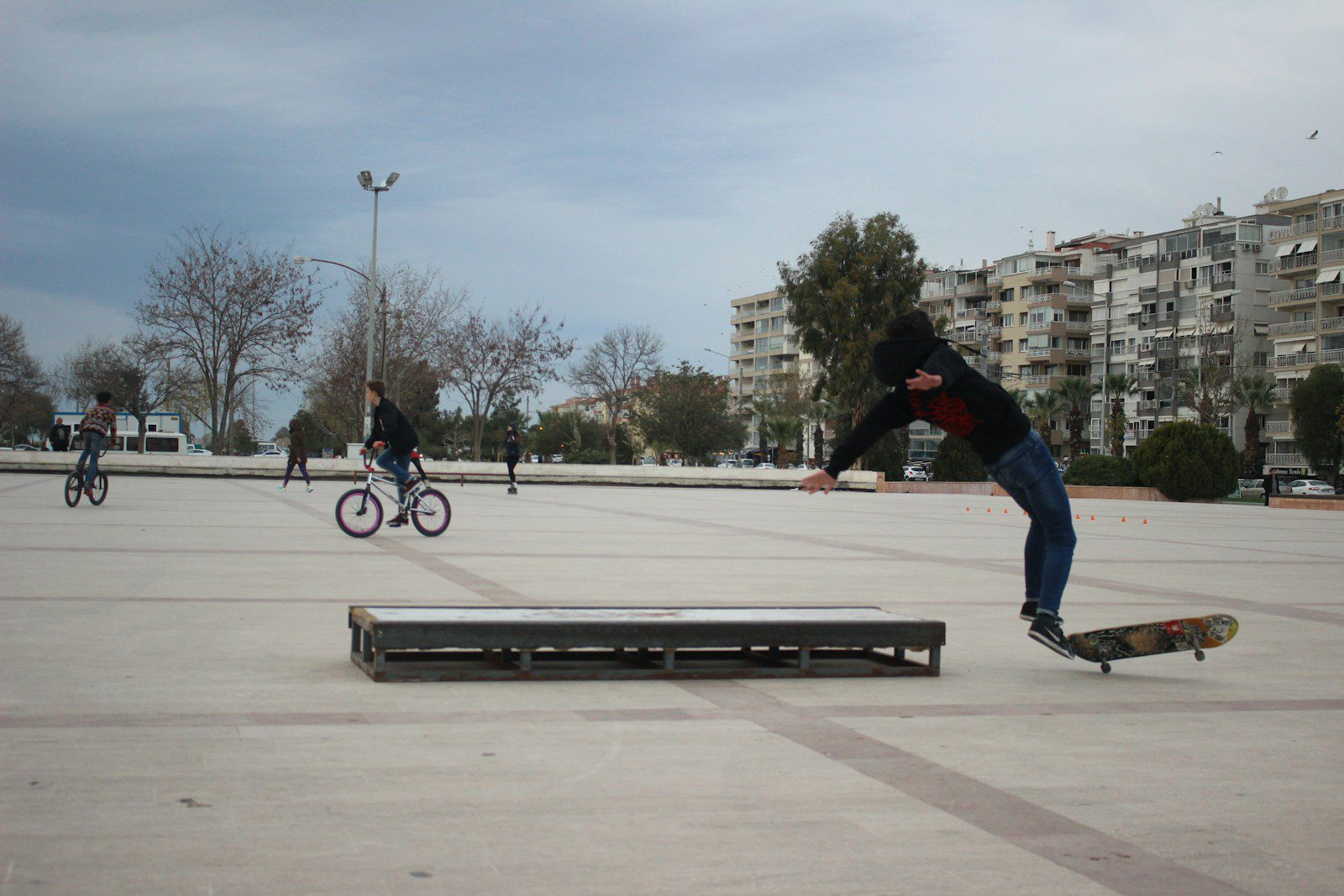 man riding at black and brown skateboard