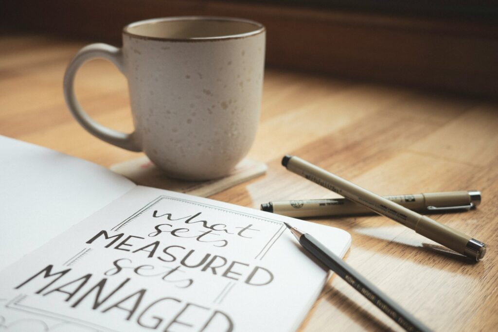 A cup of coffee sitting on top of a wooden table depicting warm quotes