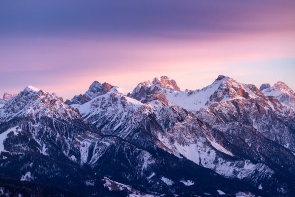 A mountain range with snow covered mountains in the background